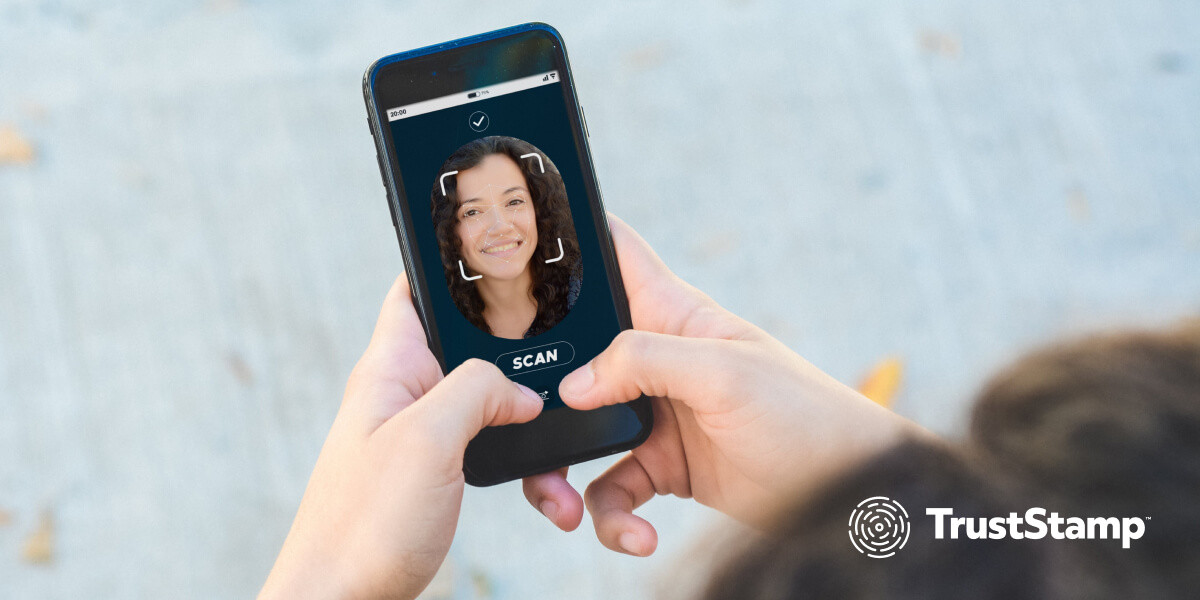 Young woman using her smartphone to perform biometric face recognition.